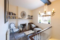 a living room with a fireplace and bookshelves