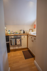 a small kitchen with a stove and oven