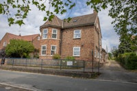 a brick house on the side of a street