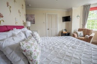 a white bed with pink flowers on it