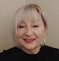 an older woman wearing a black top and hoop earrings