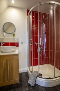 a bathroom with a glass shower stall