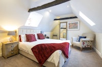 an attic bedroom with a bed and a chair